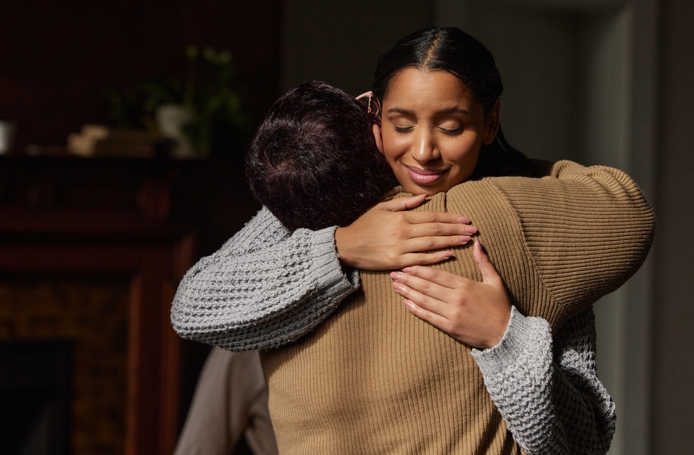 two people in a support group hugging each other