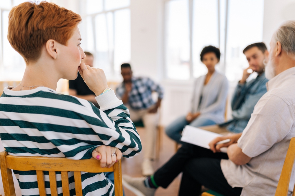 group of people sitting in a circle talking about their gambling addiction at a gamblers anonymous meeting