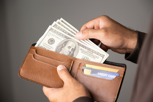 photo of a wallet full of potential gambling money